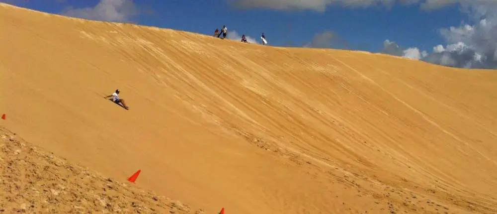 Sandboarding on sand dunes