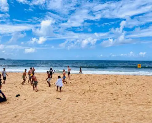 Friends playing rugby on Collaroy Beach