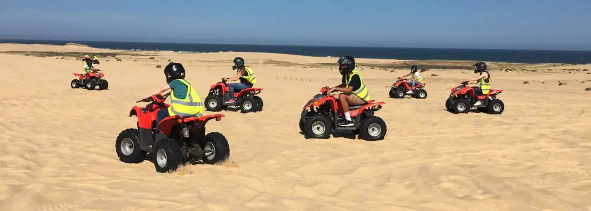 A group of people riding quad bikes