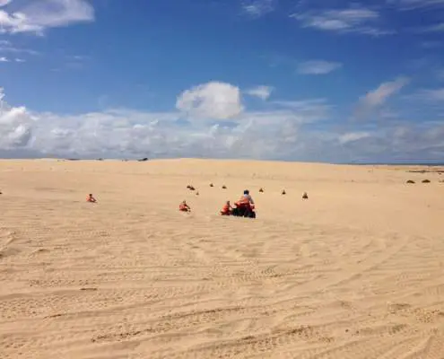 Sand dunes with quad bike riders