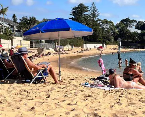 People sunbathing at Camp Cove Beach