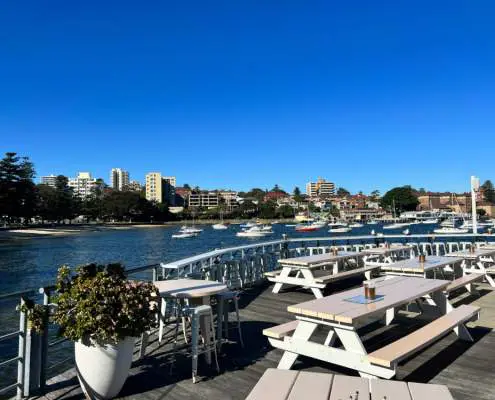 Outdoor tables overlooking East Manly Cove beach